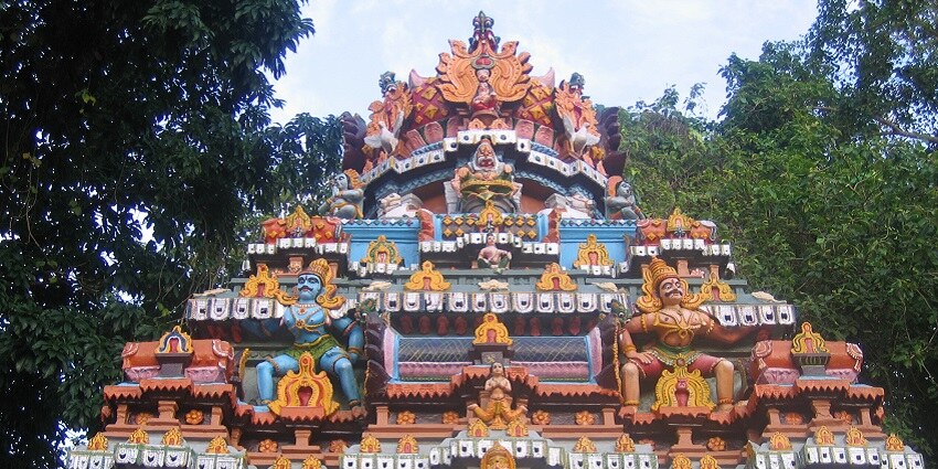 A picture of a temple with colourful walls and multiple gopurams of various deities