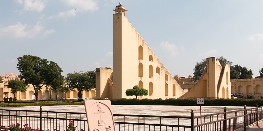 Jantar Mantar, features a massive sundial, glowing beautifully during sunset.