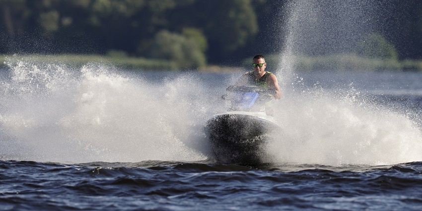 A picture of a trained person enjoying a jet ski ride at a water body