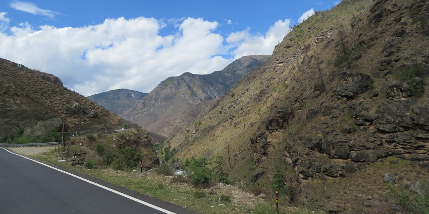 A scenic road view in Bhutan, capturing local life near Jigme Singye Wangchuck National Park.