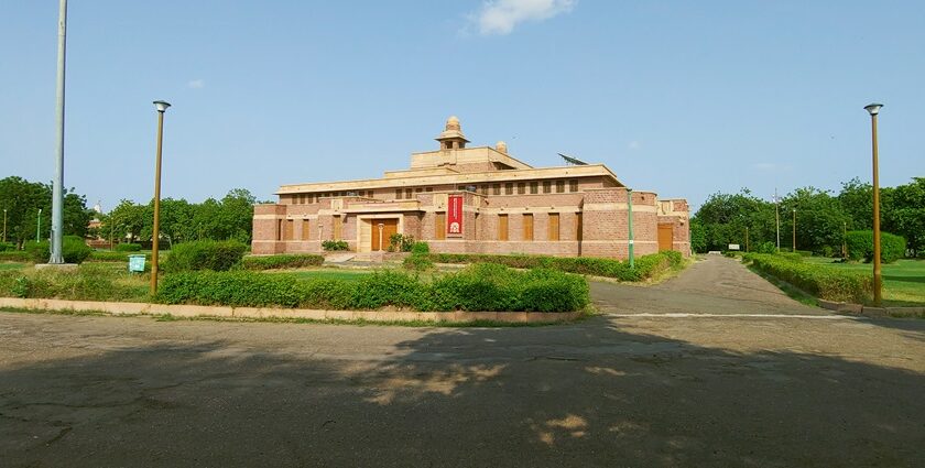 The outside view of a Jodhpur museum, Surrounded by greenery and a beautiful garden area.