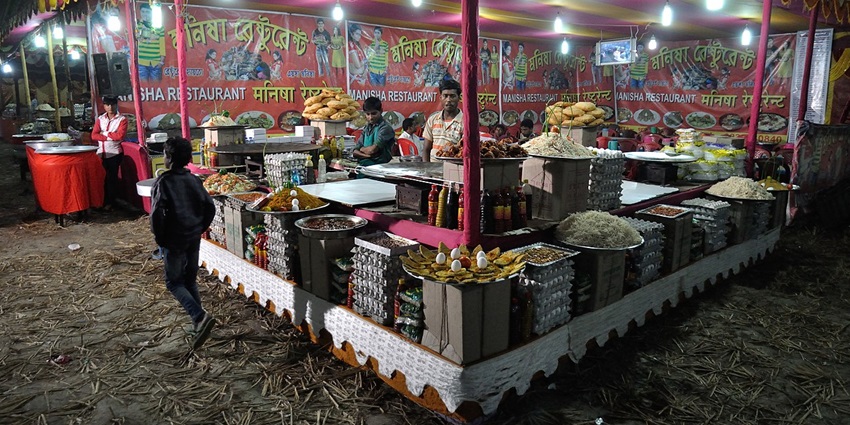 Evening food stalls at Sundarban Kristi Mela, vibrant fair with lights and local snacks