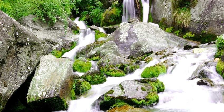 Jogini Falls near Manali, cascading down amidst lush green landscapes and scenic beauty