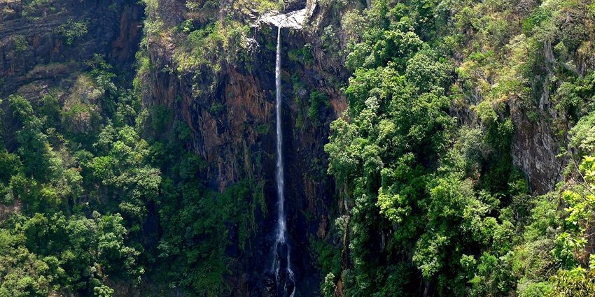 Joranda Waterfall, a famous waterfall near Mahadev Paani Waterfall cascading into a deep pool.