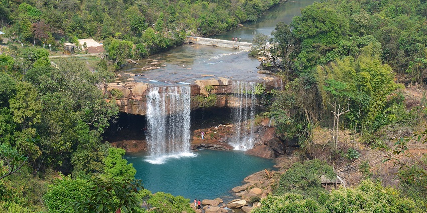 An image of a serene crystal clear hill top waterfall, resembling the Jua Falls