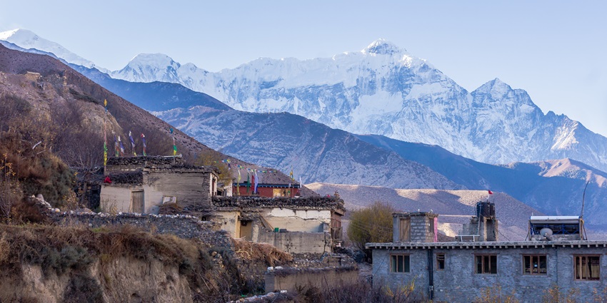Kagbeni village in Mustang, Nepal, featuring traditional houses and a scenic landscape.