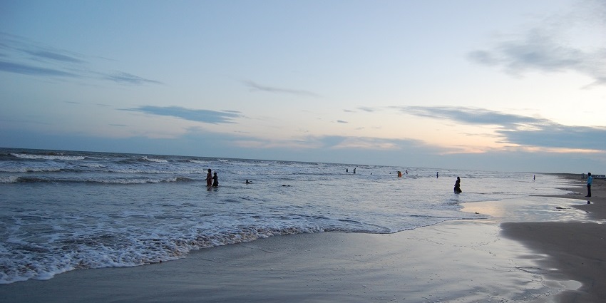 Picturesque view of the crystal clear waves crashing the rocky shores of Kakinada beach