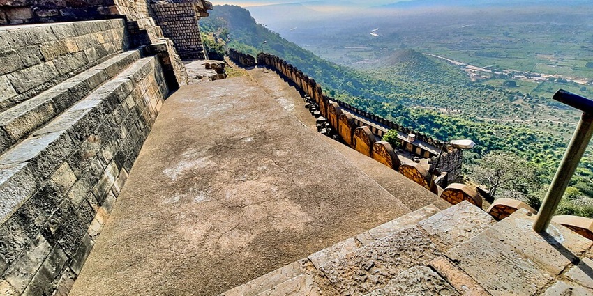Kalinjar Fort is atop a hill featuring intricate stonework and attractive scenery.