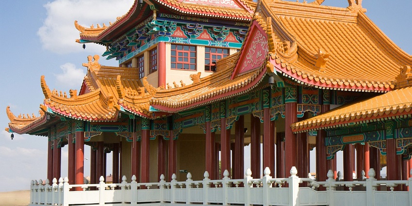 A stunning view of a Buddhist temple with a colourful exterior during the daytime.