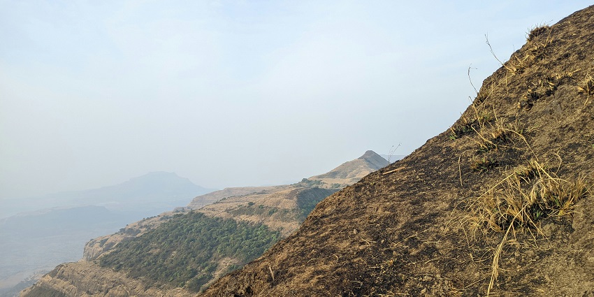 Trekking trail to Kalsubai Peak with panoramic views of the Western Ghats during the day.