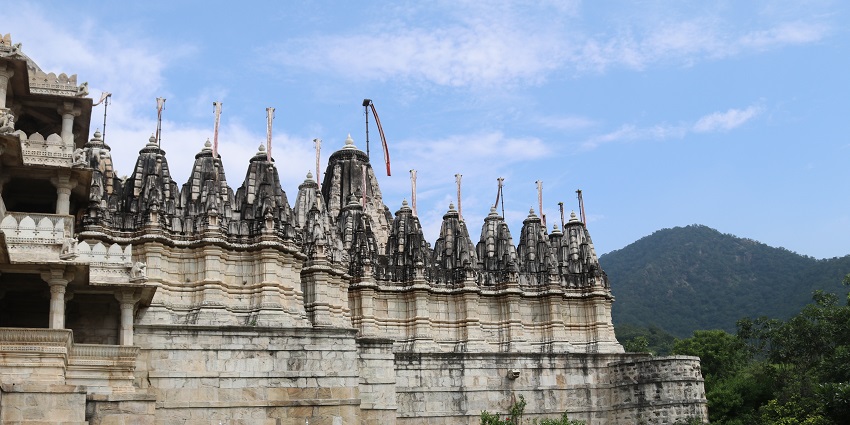 Kalyanji Temple features intricate carvings, attracting devotees amidst lush greenery.