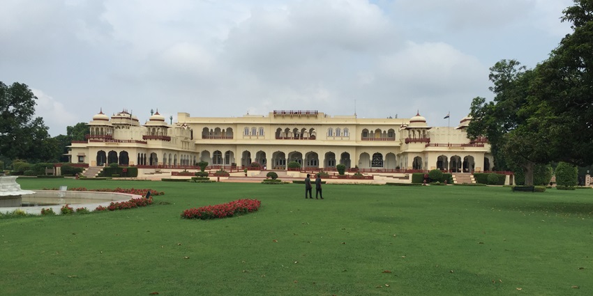Beautiful lawns of Kanak Vrindavan Garden, with a palace- like structure in the background.
