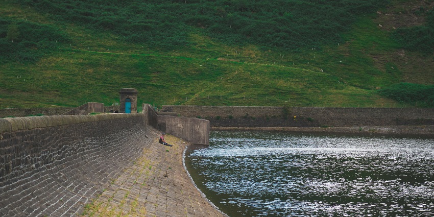 Snapshot of a man sitting on a wall by a Reservoir—places to visit near nellore