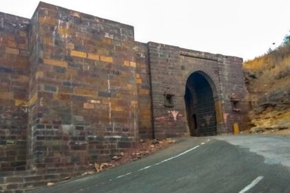 View of the entrance of the Kanthkot Fort in Gujarat, surrounded by hills and greenery.