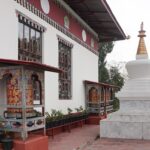 A serene view of Karbandi Monastery in Phuentsholing, Bhutan, showcasing traditional Bhutanese architecture surrounded by lush greenery.