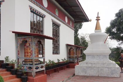 A serene view of Karbandi Monastery in Phuentsholing, Bhutan, showcasing traditional Bhutanese architecture surrounded by lush greenery.