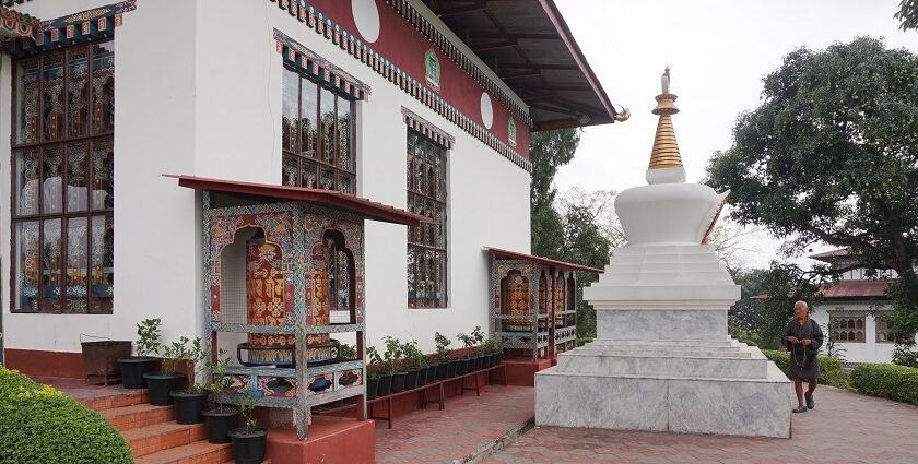 A serene view of Karbandi Monastery in Phuentsholing, Bhutan, showcasing traditional Bhutanese architecture surrounded by lush greenery.