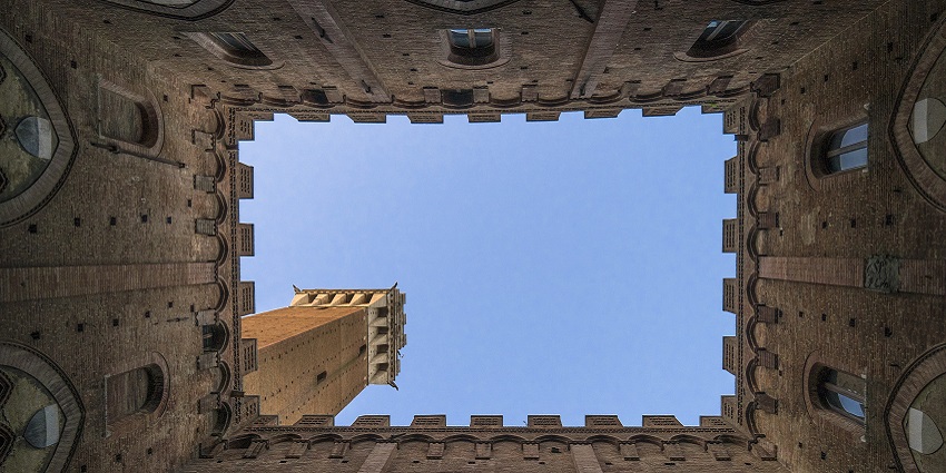 Stunning sky view through an ancient fort's window, reminiscent of the beauty of Kasara Durbar