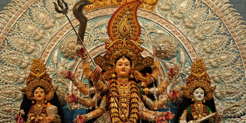 Beautiful idols for Goddess Chandi adorned with gold jewellery and colourful garments.