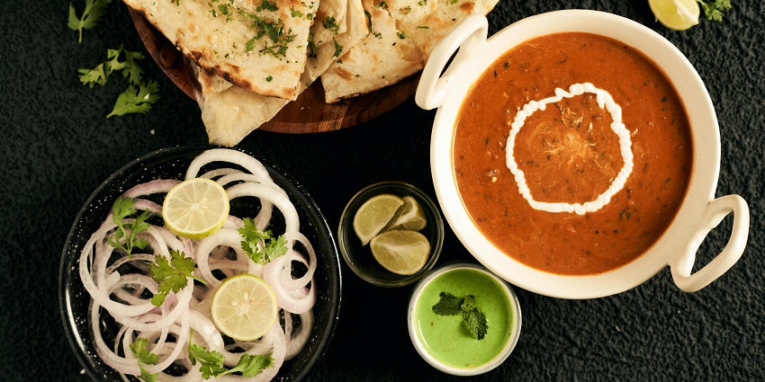 A traditional Kathiyawadi thali, with dal and roti served with onions and lemon