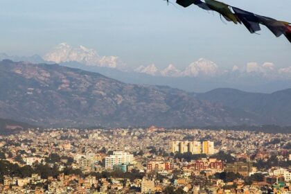 A panoramic view of Kathmandu, Nepal, showcasing the city's streets and surrounding hills.