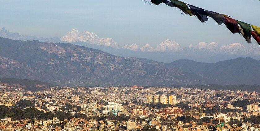 A panoramic view of Kathmandu, Nepal, showcasing the city's streets and surrounding hills.