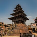 An image of a very tall building sitting in the middle of Kathmandu, the capital city of Nepal.