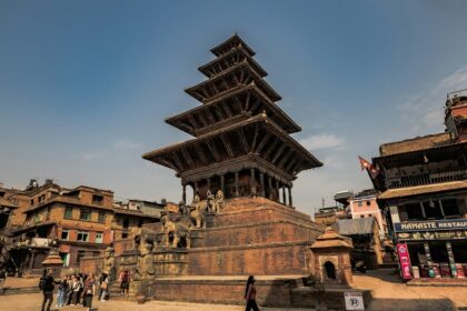 An image of a very tall building sitting in the middle of Kathmandu, the capital city of Nepal.