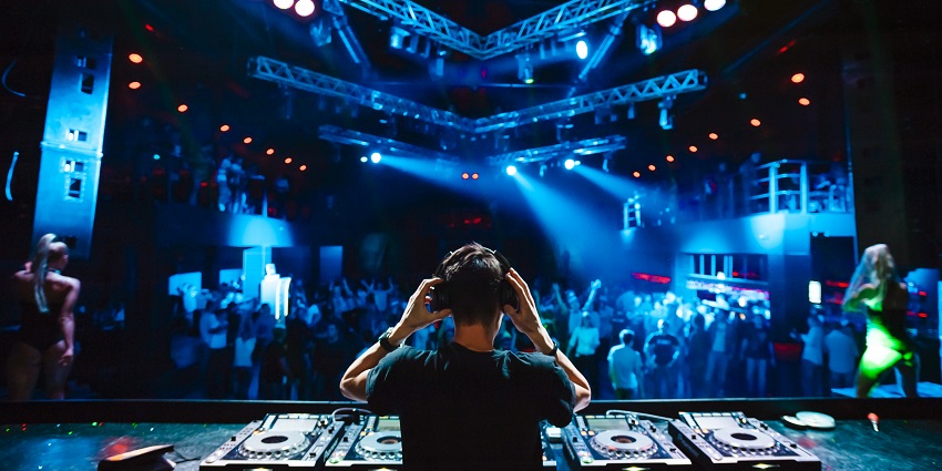 Picture of a DJ playing different variety of music for the wild crowd