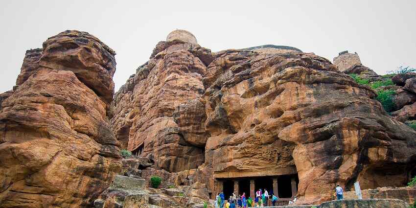 Majestic halls of the caves surrounded by lush greenery and tourists