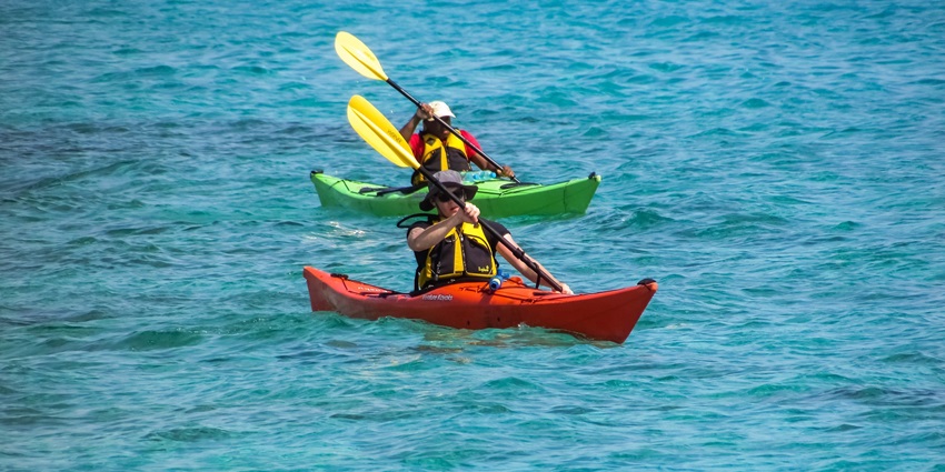 A picture of 2 people rowing their kayak in the sea near the Candolim beach