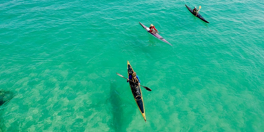 A glimpse of people enjoying kayaking on the turquoise-blue waters of the region.