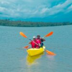 A couple going kayaking in Kerala with its scenic surroundings and lush greenery