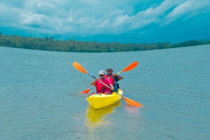 A couple going kayaking in Kerala with its scenic surroundings and lush greenery