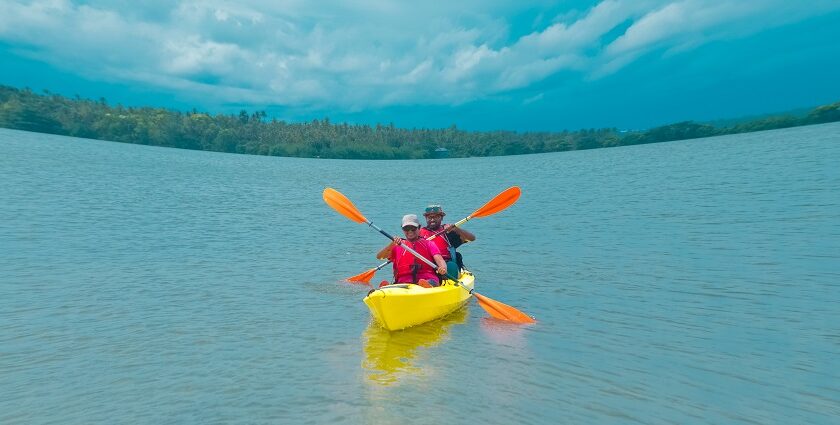 A couple going kayaking in Kerala with its scenic surroundings and lush greenery