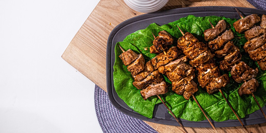 A view of mouth-watering kebabs slowly roasted to perfection and served on a plate.
