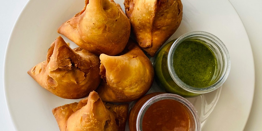 Keema samosa served with sweet and mint chutney, a delicacy enjoyed by the people as a snack
