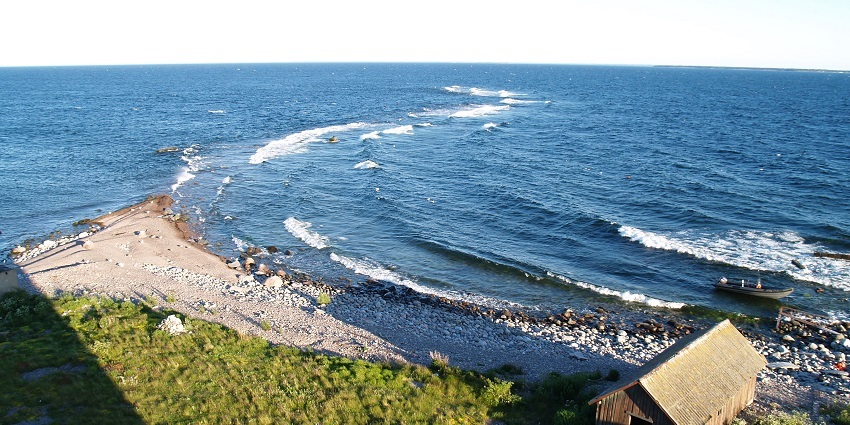 Image of Keri beach surrounded by clear blue water under blue sky and golden sand