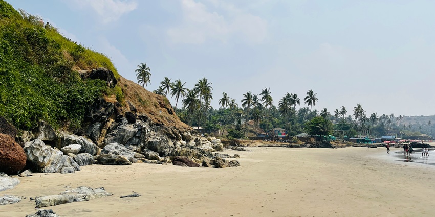 Untouched beauty of Keri Beach, surrounded by lush greenery and clear blue waters.
