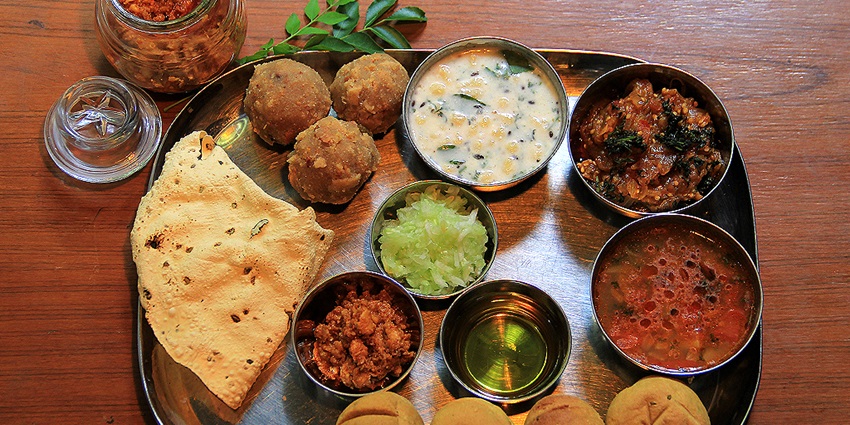A plate of dal bati and paneer curry served at Kesar Bhavan Restaurant, a family-friendly dining spot