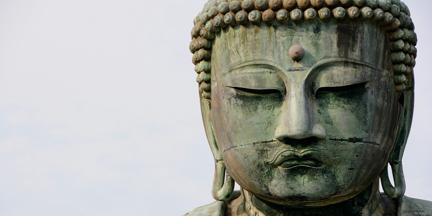 A glimpse of a phenomenal sculpture of Mahavir in grey and rustic shades of colour.