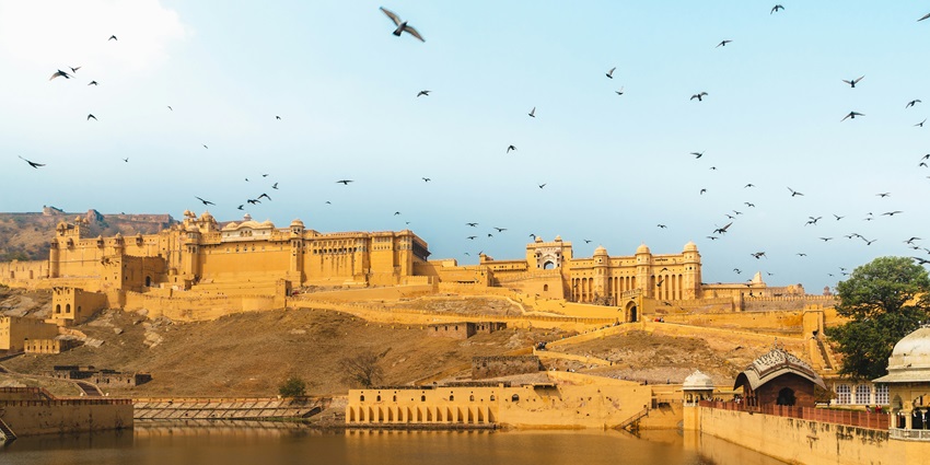 A breathtaking vista of a herd of birds flying over the popular tourist attraction.