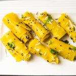 A view of a plate full of Khandvi, the popular street food in Surat which is delicious