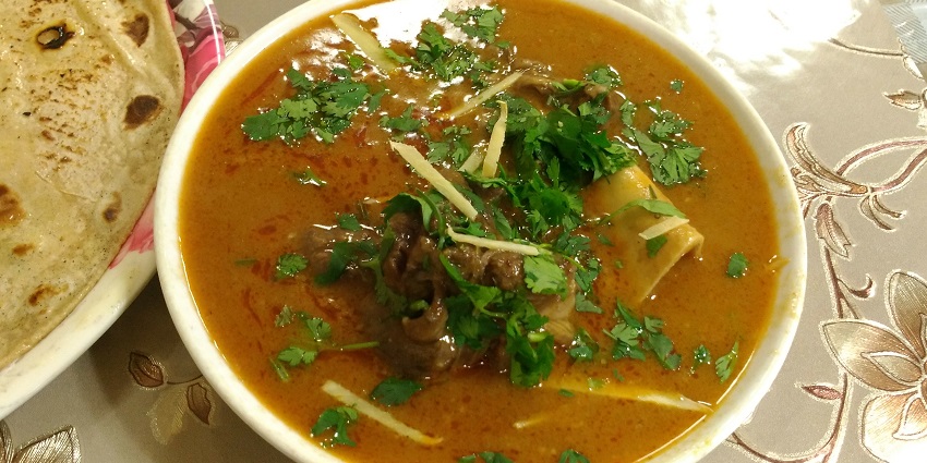 Flavorful goat trotter soup, garnished with herbs and spices - best food in Ludhiana.