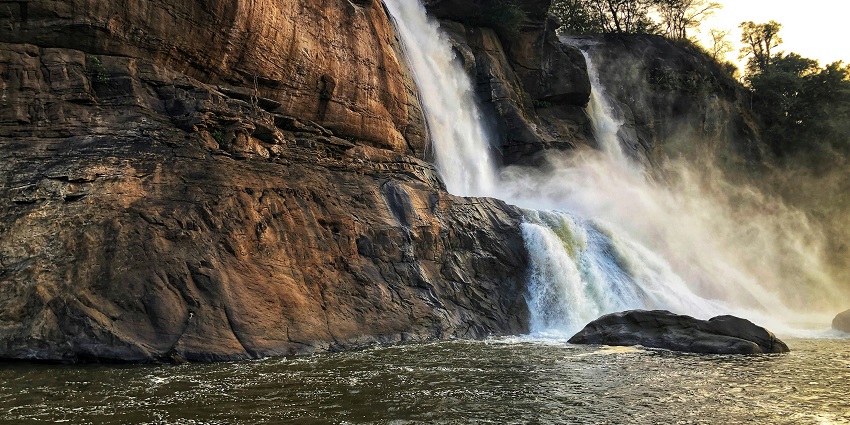 People enjoying flowing water and the top view from the Khasada Waterfall in Jiranga