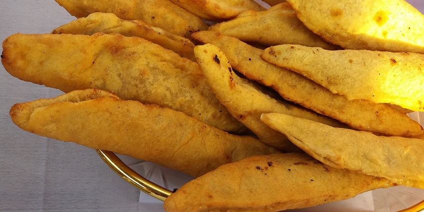 An image of Khasta, a famous dish which is a flaky pastry with spicy lentils or potatoes.
