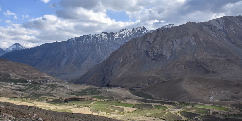 A view of the fields of the Kibber surrounded by majestic mountains in Himachal.
