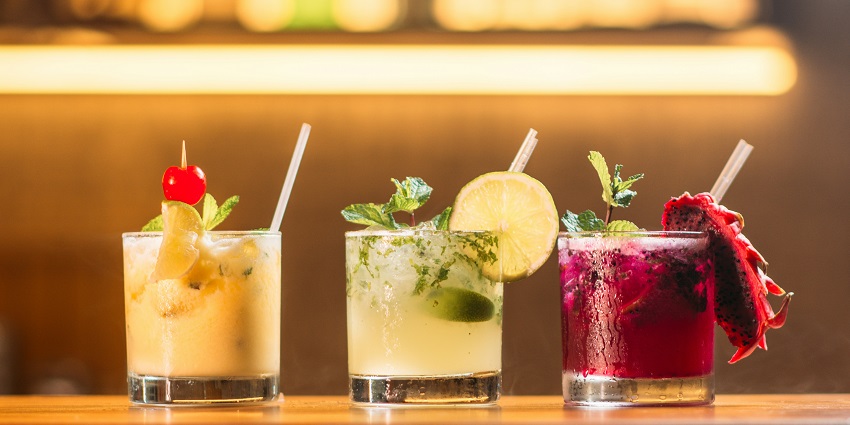 Image of three glassed Fruits Mojitos displayed with dragon fruit, mint and lemon on top