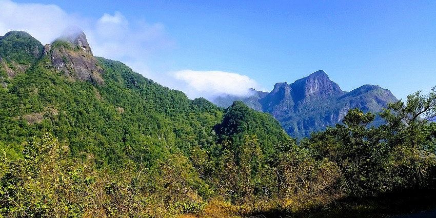 Expansive view of the Knuckles Mountain Range with lush green peaks and cloudy sky