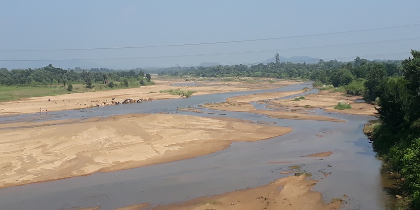 View of a river meandering through sandy shores, an ideal attraction to visit for nature lovers